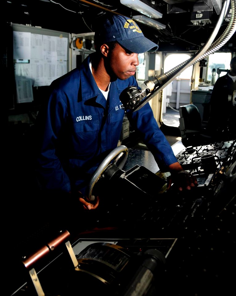 US Navy 101025-N-8913A-063 Boatswain's Mate Seaman Christian J. Collins stands the lee helmsman watch in the bridge aboard the guided-missile destr