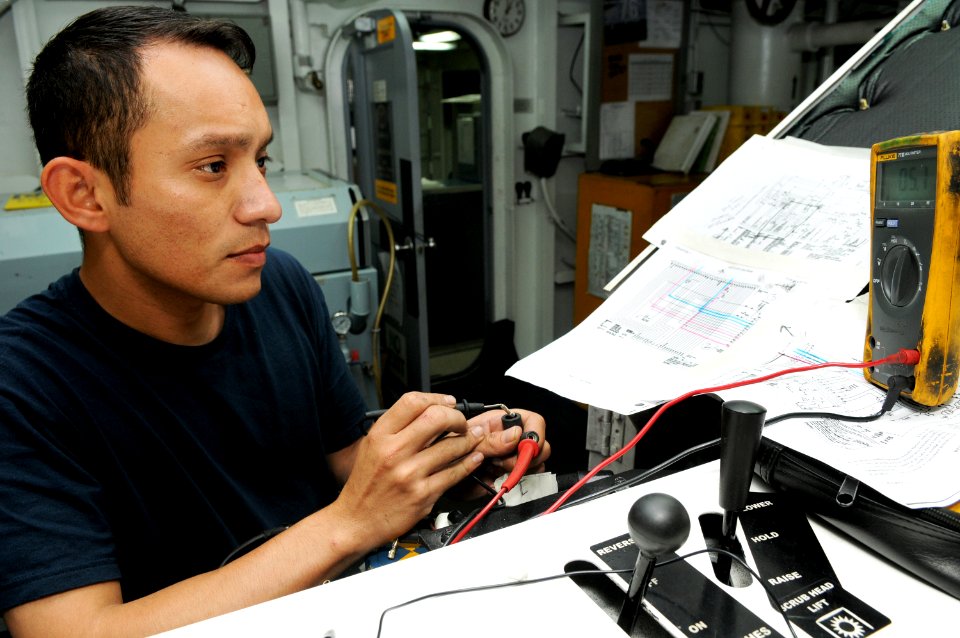 US Navy 101029-N-1004S-006 Aviation Support Equipment Technician 2nd Class Edgar Florasalba, from San Diego, checks the electrical resistance of a