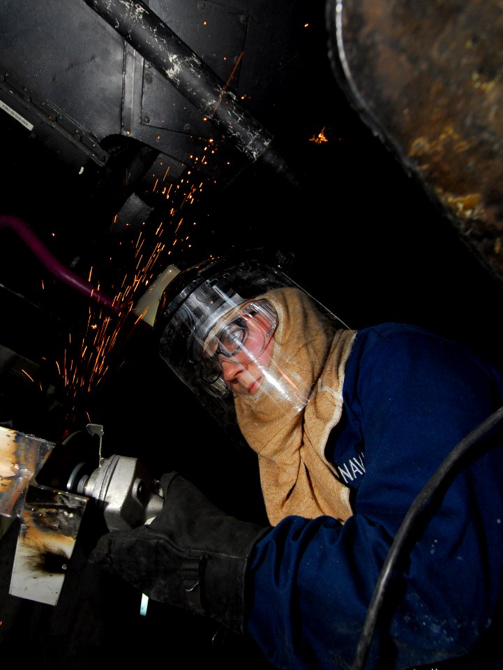 US Navy 101026-N-5031T-201 Hull Maintenance Technician Fireman Kristin Pipal, from Wolf Point, Mont., welds a bracket in the sheet metal shop aboar