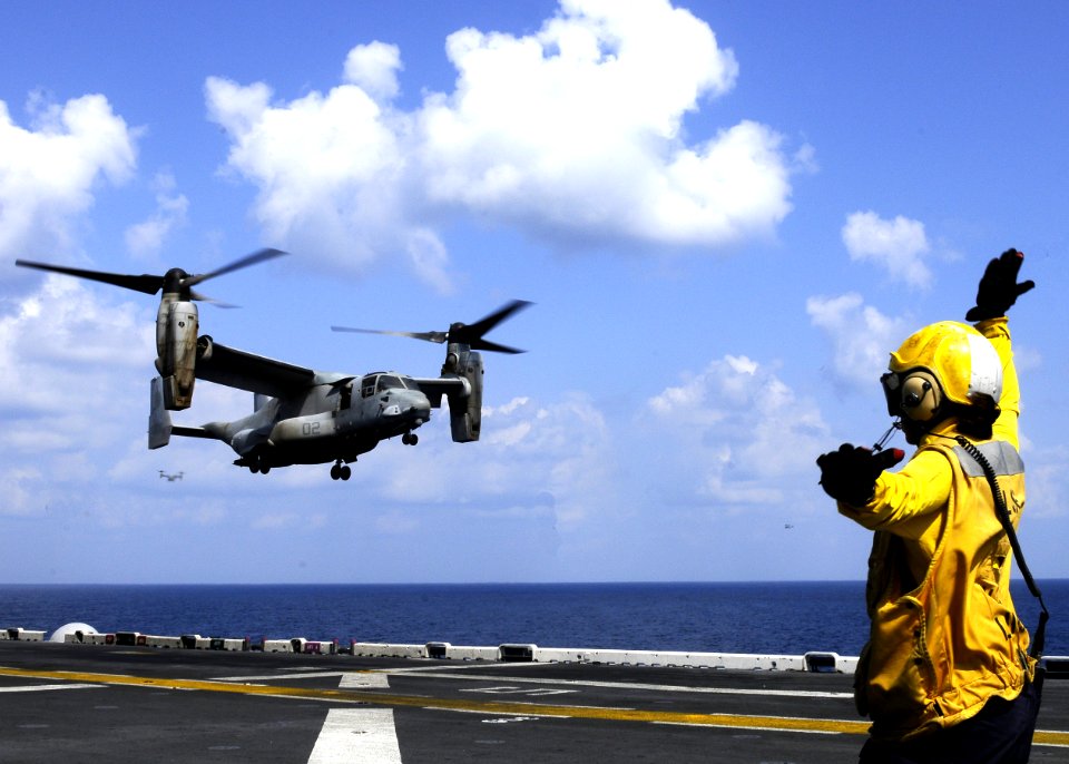 US Navy 101029-N-3154P-136 Aviation Boatswain's Mate (Handling) 3rd Class David Neiman directs an MV-22B Osprey