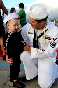US Navy 101029-N-3560G-002 Machinist Mate 1st Class Steven Bear hugs his son during a homecoming celebration for the Los Angeles-class submarine US