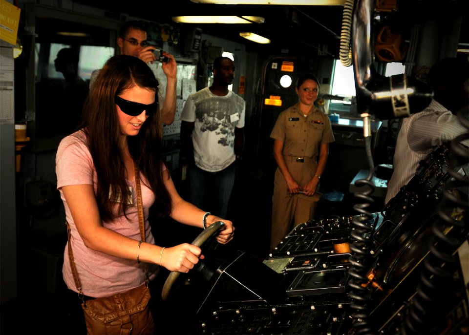 US Navy 101028-N-8590G-005 Katy Jo Muncie, a law student, holds the ship's wheel at the helm aboard the guided-missile destroyer USS The Sullivans'