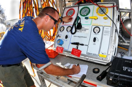 US Navy 101027-N-5812W-003 Navy Diver 2nd Class Thomas Liddy, assigned to Southeast Regional Maintenance Center at Naval Station Mayport photo