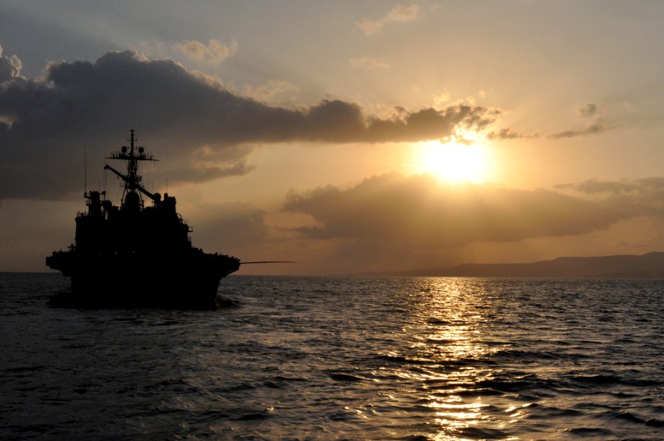 US Navy 101029-N-7293M-070 The amphibious transport dock ship USS Ponce (LPD 15) is lit by the early morning sun as the stern gate is raised after