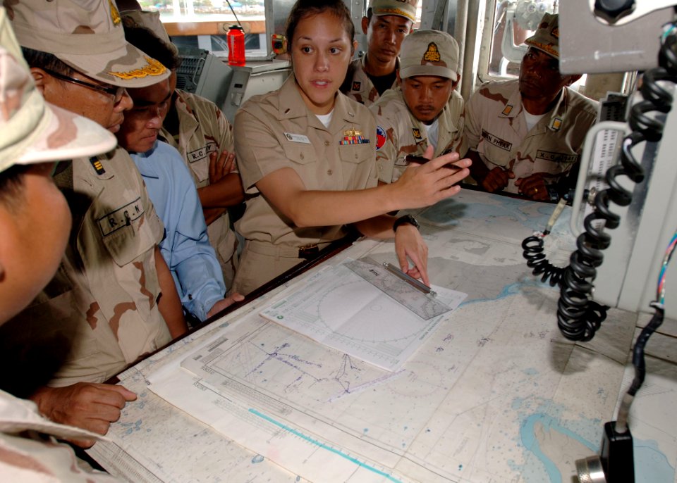 US Navy 101026-N-9156C-004 Lt. j.g. Vanessa Walton explains how she uses charts to visiting Royal Cambodian Navy officers during Cooperation Afloat