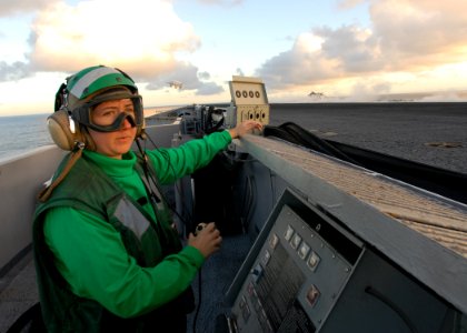 US Navy 101030-N-5684M-064 Aviation Boatswain's Mate (Equipment) 3rd Class Brittany Faircloth, from Winchester, Va., mans deck edge control as airc