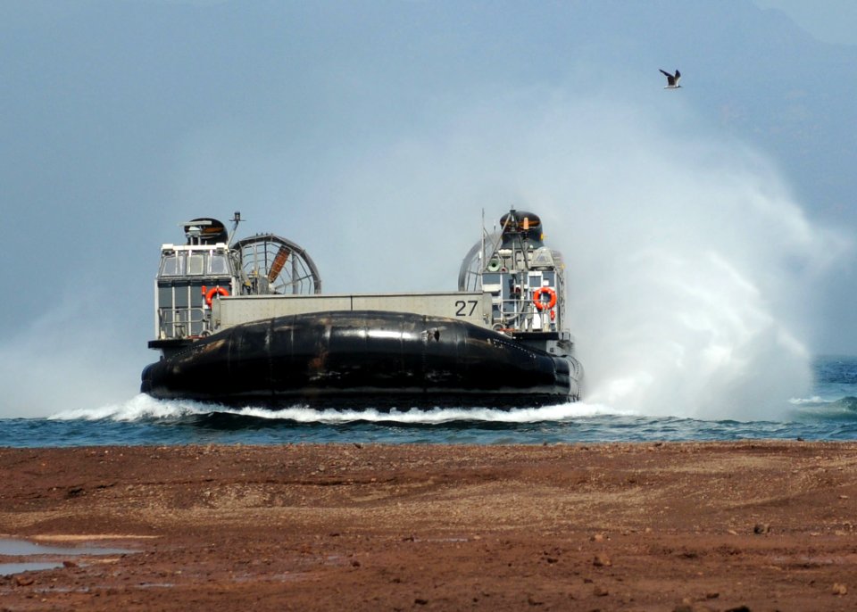 US Navy 101026-N-8069G-418 A landing craft air cushion (LCAC) from the amphibious dock landing ship USS Carter Hall (LSD 50) arrives on the beach d