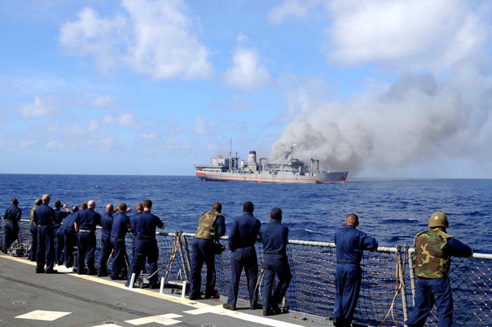 US Navy 101027-N-1854W-115 Sailors aboard the guided-missile destroyer USS Mitscher (DDG 57) observe the approach of the ex-USNS Saturn during a si