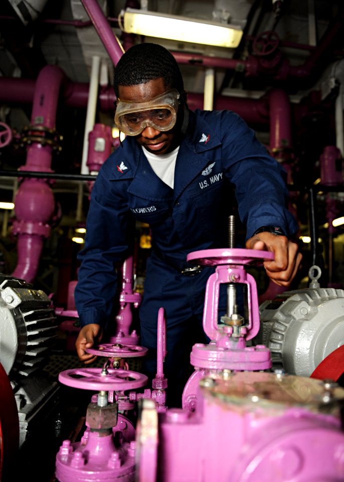 US Navy 101027-N-6427M-040 Aviation Boatswain's Mate (Fuel) 3rd Class Henry Flowers, from Shellman, Ga., opens a valve to transfer jet fuel to the