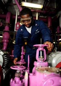 US Navy 101027-N-6427M-040 Aviation Boatswain's Mate (Fuel) 3rd Class Henry Flowers, from Shellman, Ga., opens a valve to transfer jet fuel to the