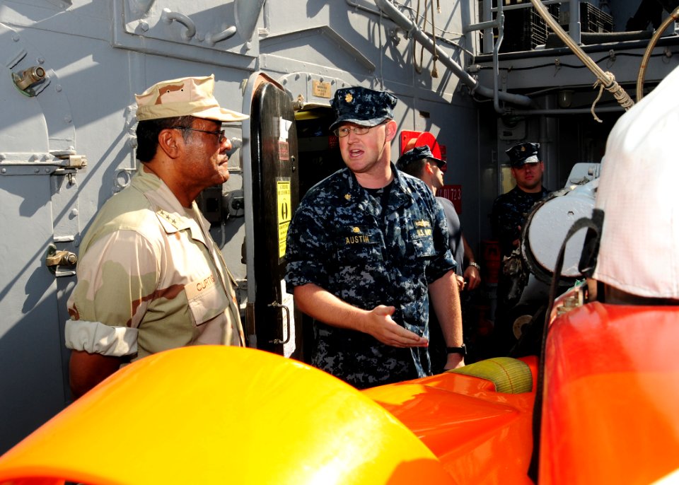 US Navy 101029-N-2903B-003 Lt. Cmdr. Spencer Austin explains the capabilities of an SLQ-48 Mine Neutralization Vehicle to Vice Adm. D.C. Curtis