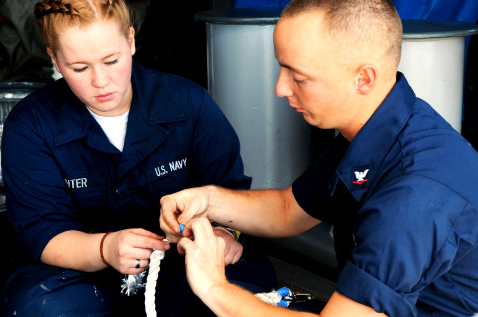 US Navy 101028-N-1004S-027 Boatswain's Mate Seaman Kaitlyn Hunter, from Flowermound, Texas, takes instruction on how to split a three-strand lifeli