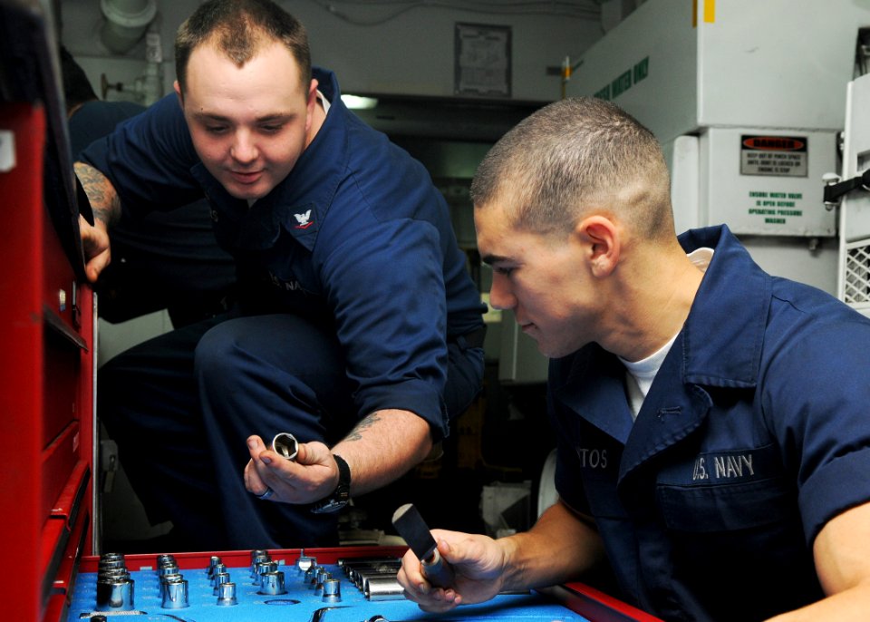 US Navy 101029-N-1004S-027 Aviation Support Equipment Technician 3rd Class Jacob Meyers shows Aviation Support Equipment Technician Airman Sean Mat