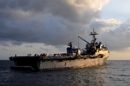 US Navy 101029-N-7293M-083 The amphibious transport dock ship USS Ponce (LPD 15) is lit by the early morning sun as the stern gate is raised after