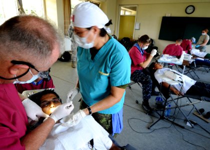US Navy 101029-N-4153W-332 Military dentists embarked aboard the multipurpose amphibious assault ship USS Iwo Jima (LHD 7) provide dental care duri