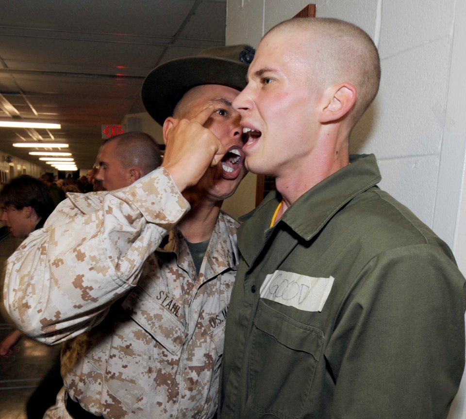 US Navy 101029-N-8848T-409 Gunnery Sgt. Robert Stahl encourages officer candidate Jared Good, from Towanda, Pa., during the first week of the 12-we