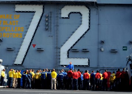 US Navy 101103-N-2821G-002 Lt. Kent Davis, flight deck officer aboard the aircraft carrier USS Abraham Lincoln (CVN 72), speaks to Sailors about fl photo