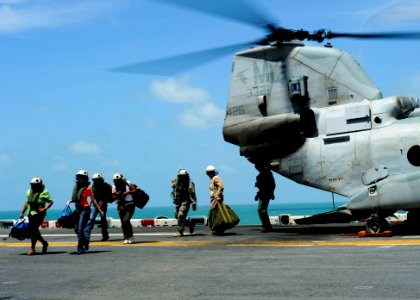 US Navy 101030-N-1531D-176 Patients from Suriname disembark from a CH-46E Sea Knight transport helicopter for medical care aboard the multi-purpose