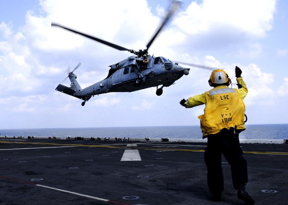 US Navy 101029-N-3154P-104 Aviation Boatswain's Mate (Handling) 3rd Class David Neiman directs an MH-60S Sea Hawk helicopter assigned to Helicopter