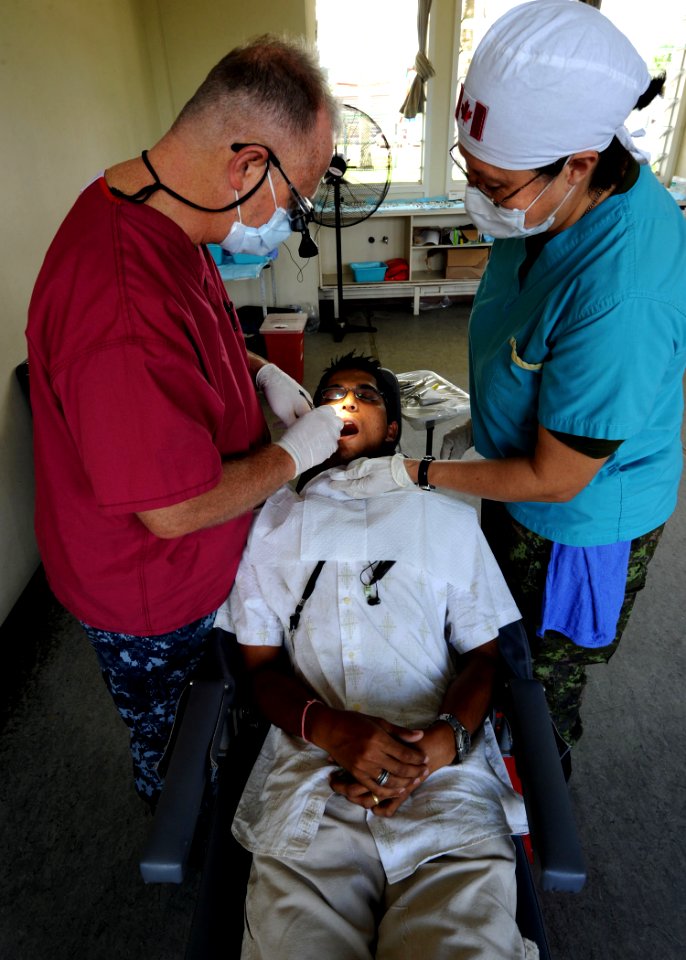 US Navy 101029-N-4153W-316 U.S. Navy Capt. Kevin Weber, left, and Canadian army Cpl. Beatriz Resendiz during a Continuing Promise 2010 medical comm