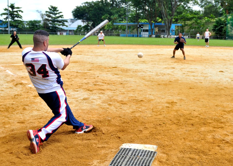 US Navy 101031-N-9950J-079 Aviation Ordnanceman 1st Class Juan Nevarez hits a softball during a game between the forward-deployed amphibious assaul