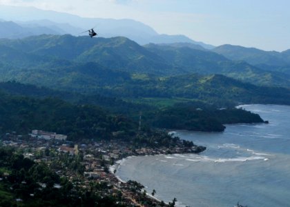 US Navy 101106-N-1531D-051 A CH-46E Sea Knight helicopter conducts aerial damage assessments of Haiti after Hurricane Tomas made landfall photo