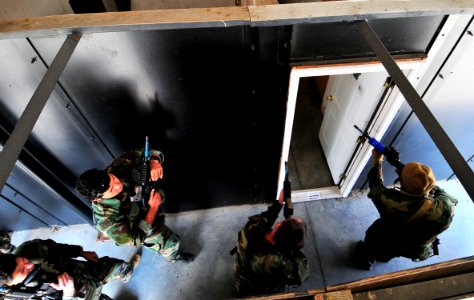 US Navy 101106-N-4044H-009 Navy SEALs enter a simulated home while practicing close quarters combat at U.S. Training Center Moyock