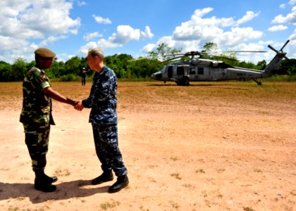 US Navy 101031-N-1531D-255 Capt. Thomas Negus, commodore of Continuing Promise 2010, bids farewell to the commanding officer of a Suriname army bat photo