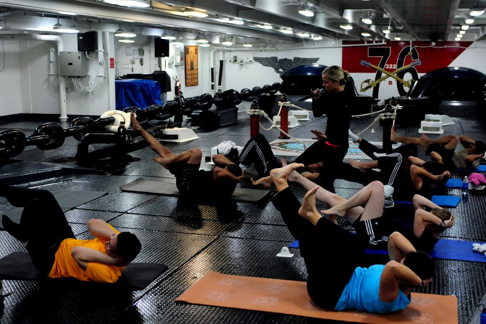 US Navy 101103-N-5503T-039 Certified yoga instructor Katherine Alfredo leads Sailors and Marines in a yoga class in the forecastle of the aircraft