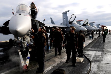 US Navy 101107-N-0232G-044 Sailors assigned to the Black Knights of Strike Fighter Squadron (VFA) 154 perform cleaning and maintenance on an F-A-18