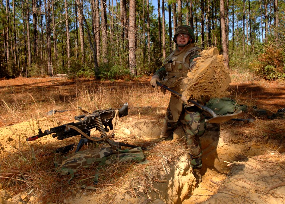 US Navy 101104-N-8816D-008 Chief Steelworker Corey Mead, assigned to Naval Mobile Construction Battalion (NMCB) 133, digs a fighting position during training