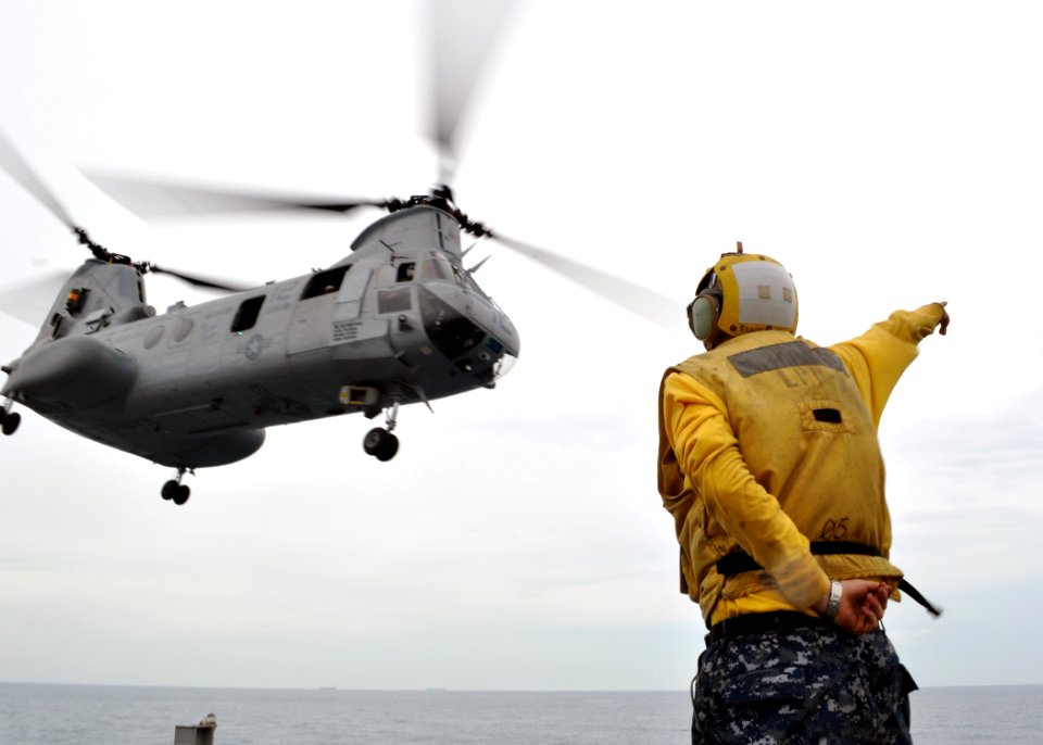 US Navy 101108-N-3620B-022 Aviation Support Equipment Technician 2nd Class Dean McRae signals for a CH-46E Sea Knight helicopter assigned to the F