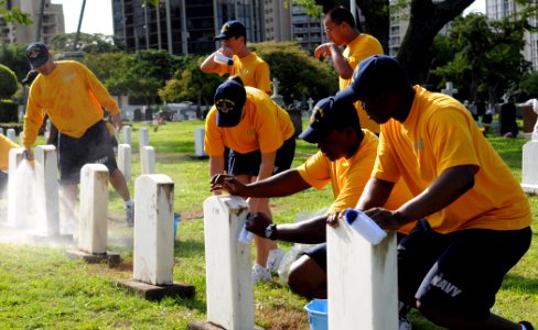 US Navy 101109-N-3666S-003 Sailors assigned to various commands at Joint Base Pearl Harbor-Hickam clean headstones at the Oahu Cemetery in Honolulu