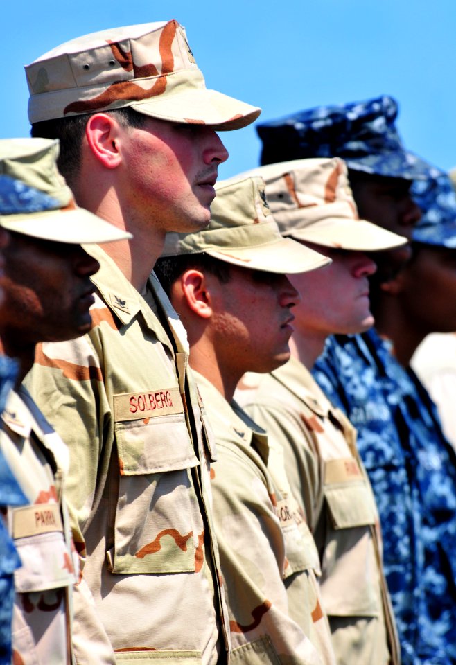 US Navy 101105-N-7948R-028 Sailors stand at attention during an Enlisted Surface Warfare Specialist pinning ceremony aboard the amphibious dock lan