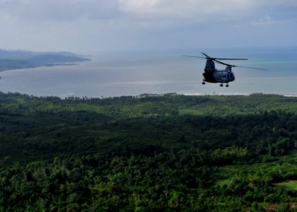 US Navy 101106-N-1531D-030 A CH-46E Sea Knight helicopter conducts aerial damage assessments of Haiti after Hurricane Tomas made landfall photo