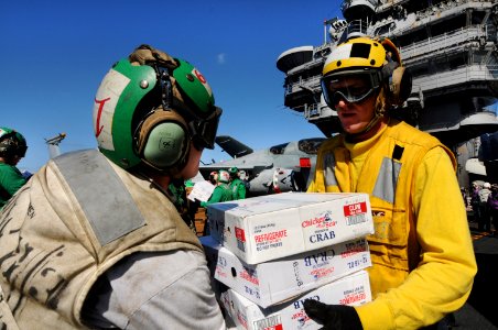 US Navy 101109-N-9132C-071 Sailors aboard the aircraft carrier USS Ronald Reagan (CVN 76) take boxes of food supplies off a C-2A Greyhound logistic