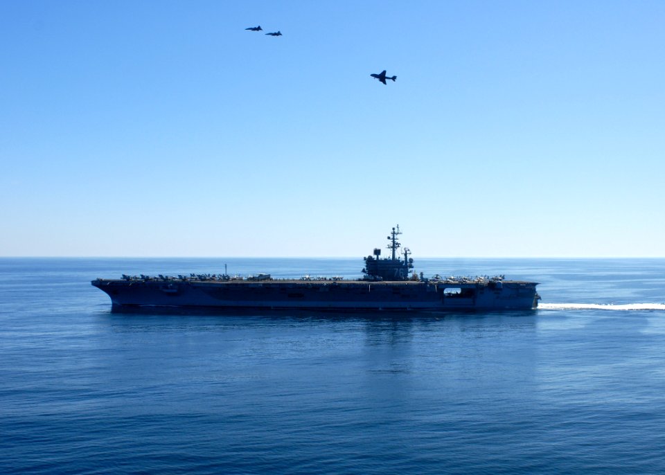 US Navy 101105-N-5684M-418 F-A-18 Hornets fly over the aircraft carrier USS Ronald Reagan (CVN 76)
