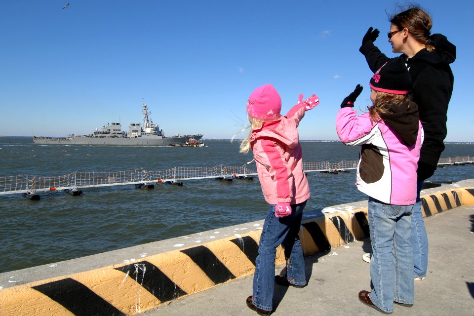 US Navy 101107-N-5292M-312 Family members of Fire Controlman Jason Bluhm wave goodbye as the guided-missile destroyer USS Mahan (DDG 72) departs Na