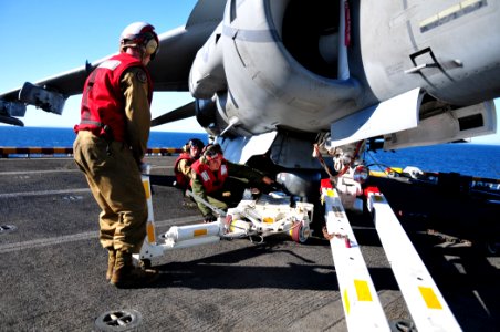 US Navy 101111-N-1722W-021 Cpl. John Lee, left, Cpl. Eric Perez, and Cpl. Kevin Kahn install a lightning pod on an AV-8B Harrier from the Evil Eyes