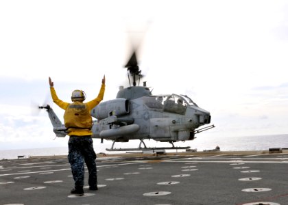US Navy 101112-N-8113T-113 Aviation Support Equipment Technician 2nd Class Dean T. McRae launches an AH-1W Cobra helicopter assigned to the Flying