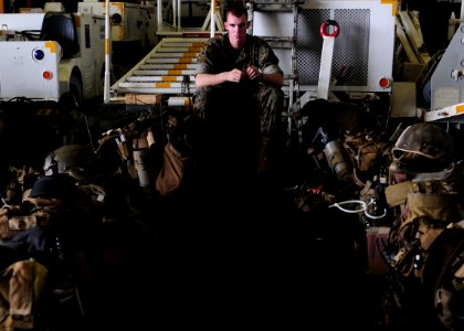 US Navy 101108-N-5538K-002 Lance Cpl. Tristan J. Hunter, assigned to the 31st Marine Expeditionary Unit (31st MEU), watches over Marine equipment i