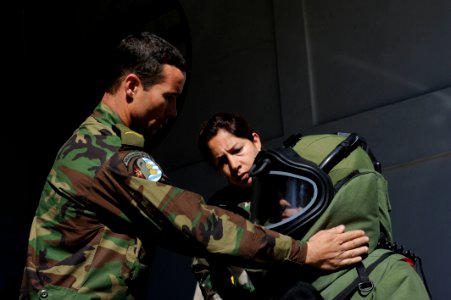 US Navy 101112-N-8546L-344 Uruguayan explosive ordnance disposal technicians help a fellow soldier don a bomb disposal suit photo