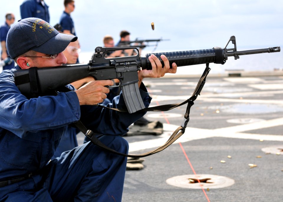 US Navy 101109-N-8113T-146 Quartermaster 3rd Class Michael Reilly shoots an M-16 rifle during a weapons qualification course aboard the amphibious