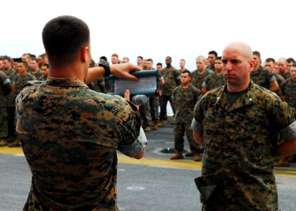 US Navy 101110-N-2218S-023 A Marine assigned to the 31st Marine Expeditionary Unit (31st MEU) reads a message from Lt. Gen. John Lejeune photo