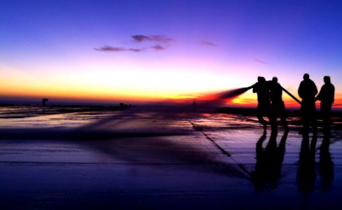 US Navy 101114-N-5503T-022 Sailors hose down the flight deck of the aircraft carrier USS Ronald Reagan (CVN 76) to clean saltwater spray off the sh