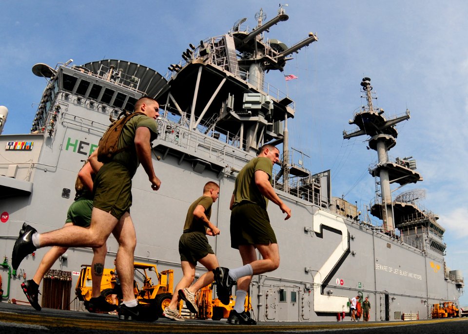 US Navy 101109-N-5538K-041 Marines assigned to the 31st Marine Expeditionary Unit (31st MEU) run on the flight deck of the forward-deployed amphibi