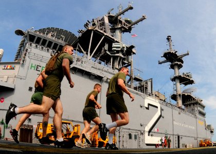 US Navy 101109-N-5538K-041 Marines assigned to the 31st Marine Expeditionary Unit (31st MEU) run on the flight deck of the forward-deployed amphibi photo