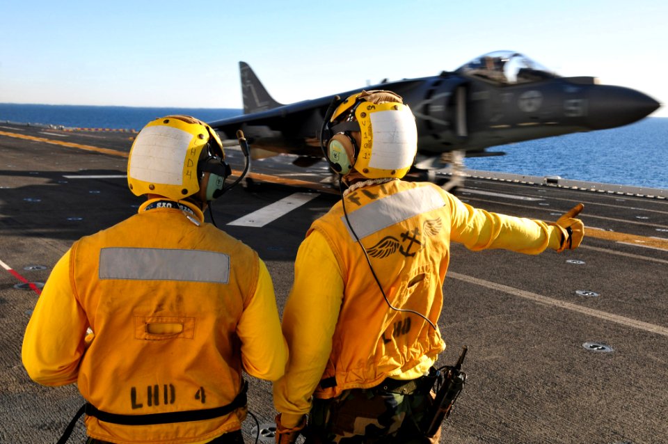 US Navy 101111-N-1722W-141 Aviation Boatswain's Mate (Handling) 2nd Class Steven Exum, left, from San Bernadino, Calif. and Aviation Boatswain's Ma