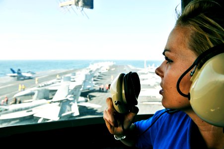 US Navy 101111-N-6003P-244 Aviation Boatswain's Mate (Handling) Airman Audrey Miller communicates with flight deck control from the flight deck cam