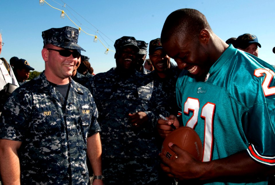 US Navy 101109-N-7948C-094 Miami Dolphin cornerback Vontae Davis signs a football for Chief Warrant Officer 2nd Mike Puit during a tour of the guid